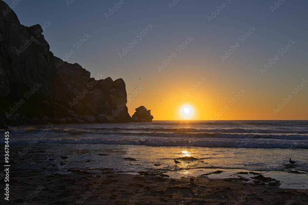 The sun sets over the Pacific in Morro Bay, California The sun sets over the Pacific in Morro Bay, California