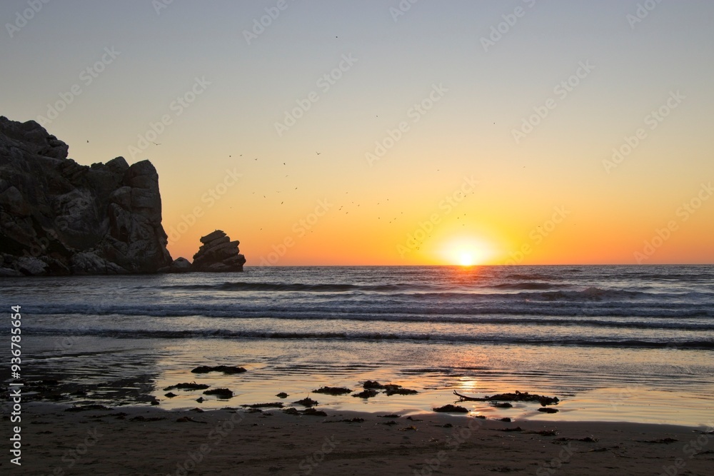 The sun sets over the Pacific in Morro Bay, California The sun sets over the Pacific in Morro Bay, California