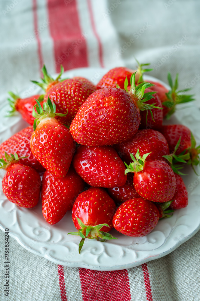 Plate with french organic red ripe sweet strawberries Fraises de Plougastel, harvested in France Plate with french organic red ripe sweet strawberries Fraises de Plougastel, harvested in France