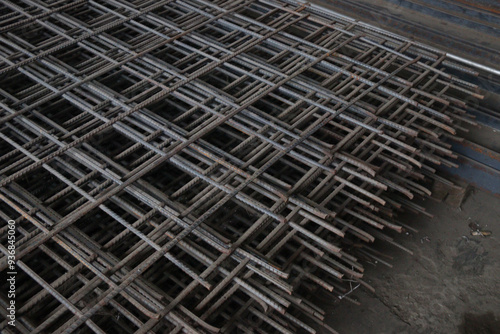 Close-up of stacked steel rebar grids, essential for reinforcing concrete in construction projects. Ideal for illustrating industrial and architectural concepts