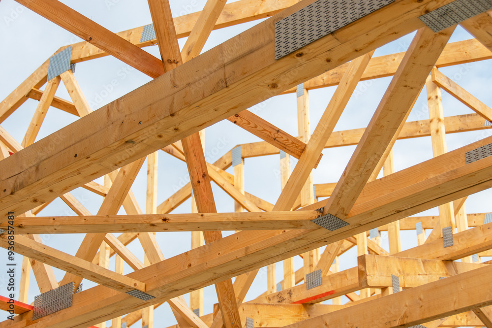 Detailed View of Wooden Roof Trusses, Beams, and Structure Under Construction against a Clear Sky, Showcasing Modern Architectural Techniques and Craftsmanship Detailed View of Wooden Roof Trusses, Beams, and Structure Under Construction against a Clear Sky, Showcasing Modern Architectural Techniques and Craftsmanship