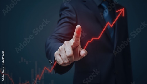 A businessman pointing at a rising graph, symbolizing growth and success in finance, business analysis, and investment strategies.