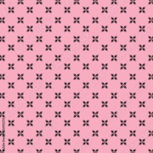 Simple geometric floral pattern black and pink background.