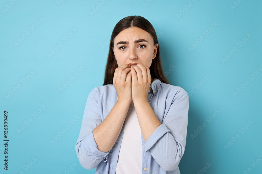 Portrait of scared woman on light blue background Portrait of scared woman on light blue background