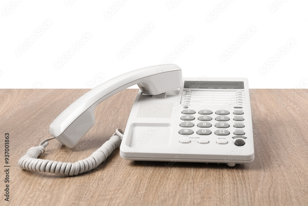 Telephone on wooden table against light background Telephone on wooden table against light background