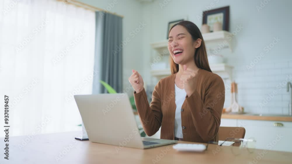 Funny euphoric young asian woman celebrating winning or getting ecommerce shopping offer on computer laptop. Excited happy girl winner looking at notebook celebrating success Funny euphoric young asian woman celebrating winning or getting ecommerce shopping offer on computer laptop. Excited happy girl winner looking at notebook celebrating success