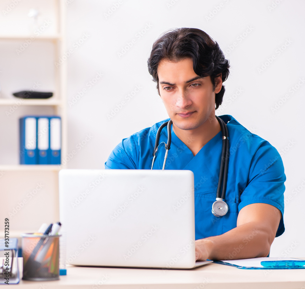 Young handsome doctor working at the clinic Young handsome doctor working at the clinic