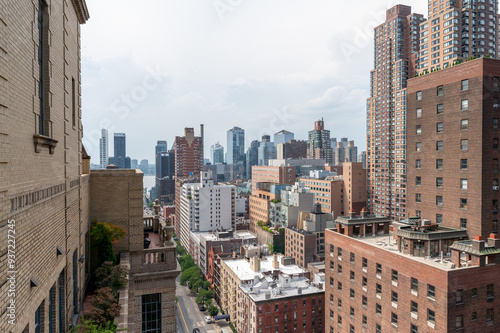 Canvas Print This striking New York City photo captures the contrast between towering modern skyscrapers and historic brick buildings, all viewed from a rooftop perspective