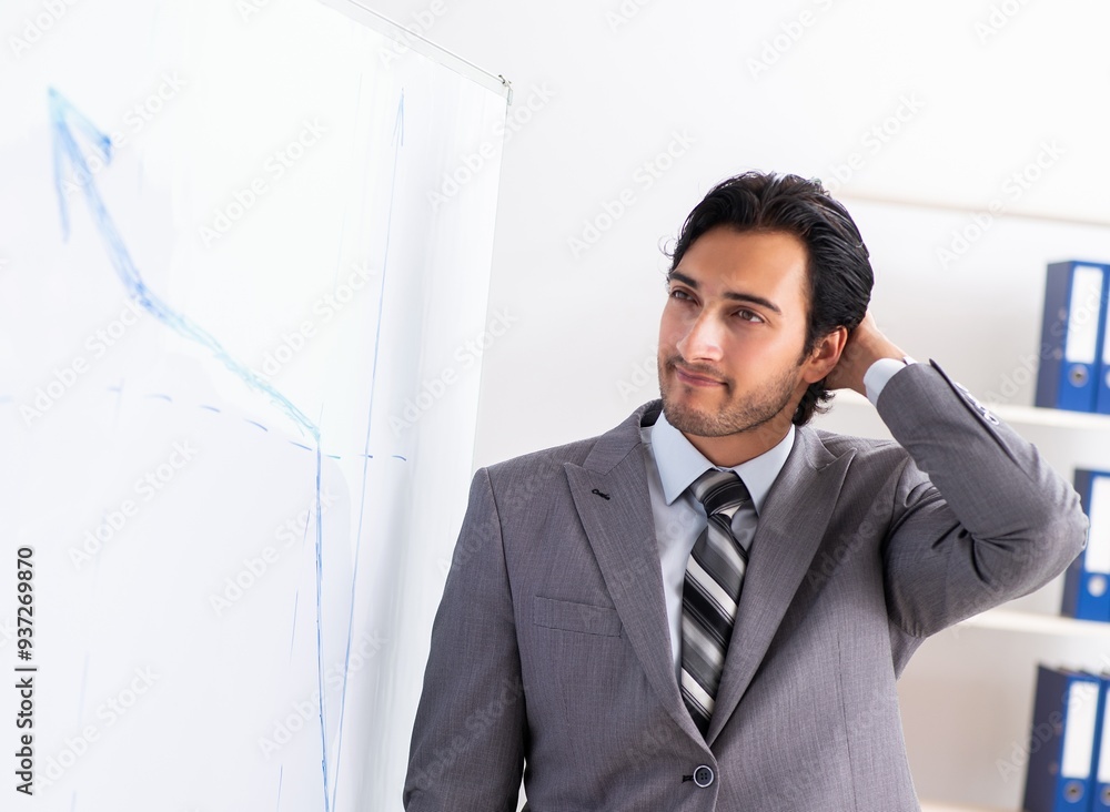Young handsome businessman in front of whiteboard Young handsome businessman in front of whiteboard