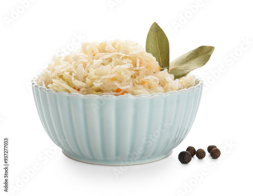 Bowl of sauerkraut with bay leaves and peppercorn on white background photo