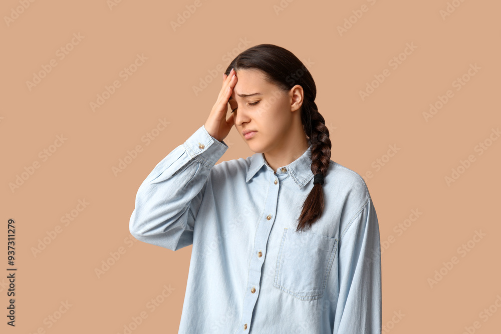 Beautiful young woman suffering from headache on beige background Beautiful young woman suffering from headache on beige background