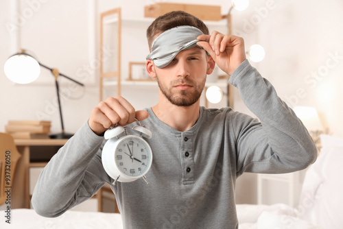 Young man in sleeping mask ...