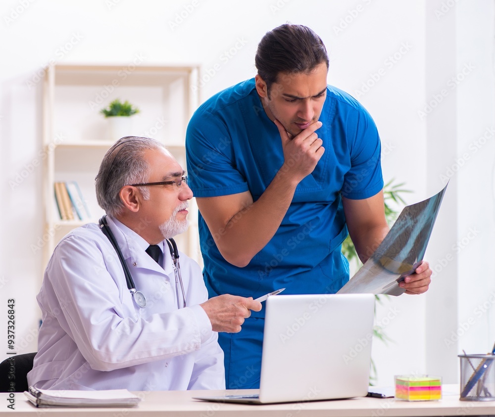 Fototapeta premium Two male doctors working in the clinic