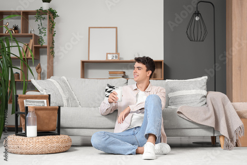 Young man with glass of mil...