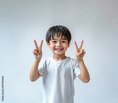 Studio shot, boy gesturing peace