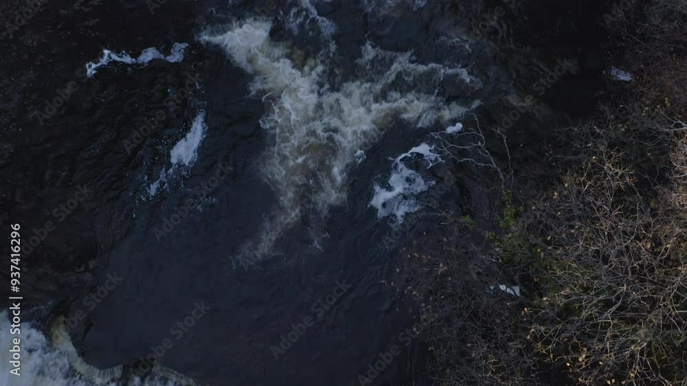 Drone overview of rushing water down waterfall in Isle of Skye Scotland with sun flare Drone overview of rushing water down waterfall in Isle of Skye Scotland with sun flare