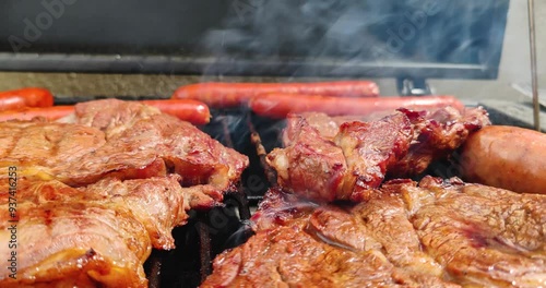 Different types of meat on a charcoal grill along with Spanish corizo ​​and chistorra for the birthday celebration on the outskirts of Mexico City one August afternoon photo