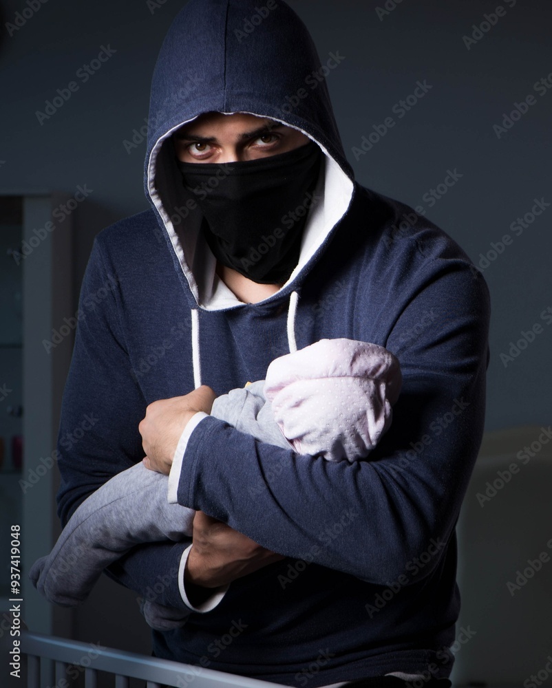Criminal stealing baby in human child traficking concept