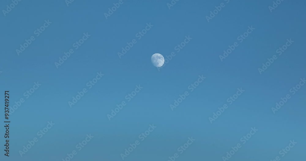 Waxing Gibbous Moon against blue sky time lapse Waxing Gibbous Moon against blue sky time lapse
