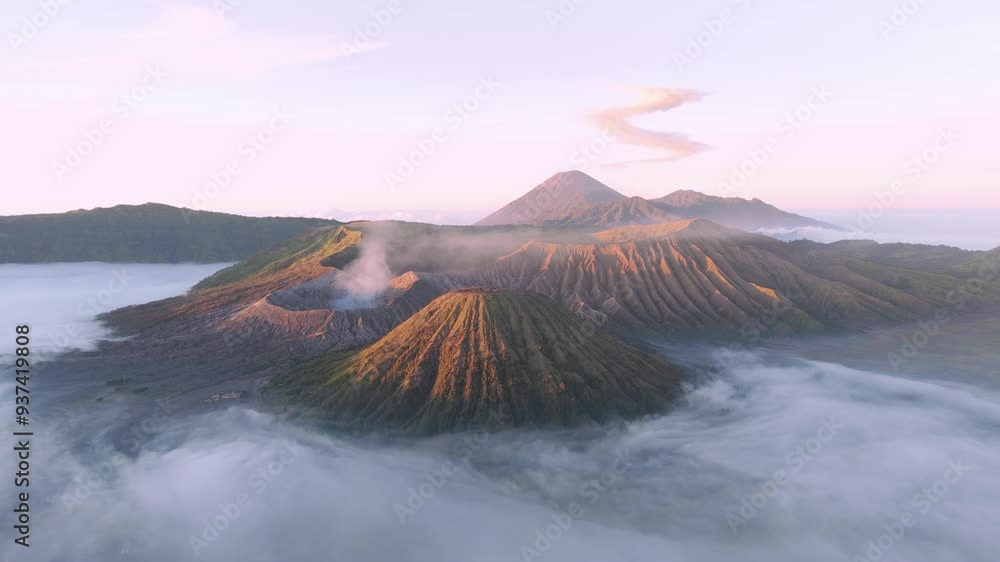 Aerial establishing shot of the active Mount Bromo surrounded my low lying mist Aerial establishing shot of the active Mount Bromo surrounded my low lying mist