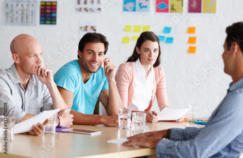 Meeting, office and portrait of man with team in discussion for planning, collaboration and feedback. Creative startup, design agency and business people for advertising, marketing and project review