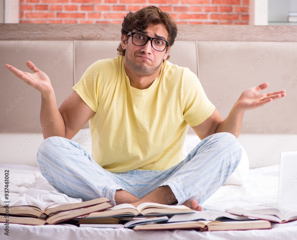 Young student studying in bed for exams Young student studying in bed for exams