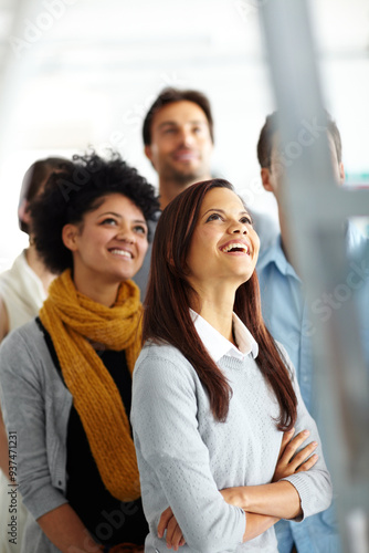 Business people, smile and looking up in office for workshop, presentation or safety training with ladder. Diversity, group and employees in workplace for team building, collaboration and meeting