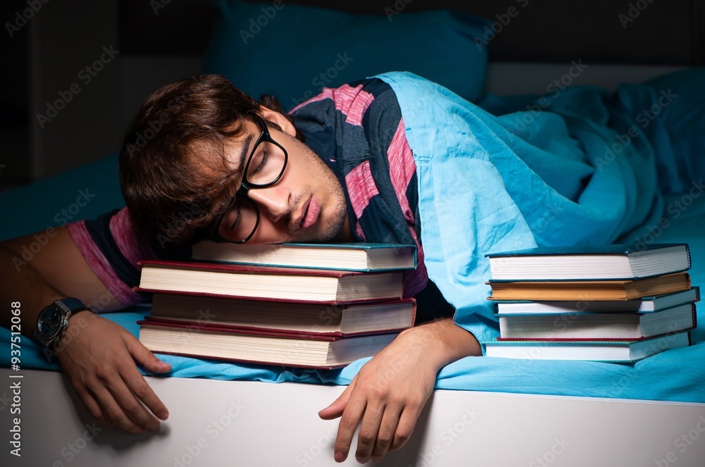 Young student preparing for exams at night at home