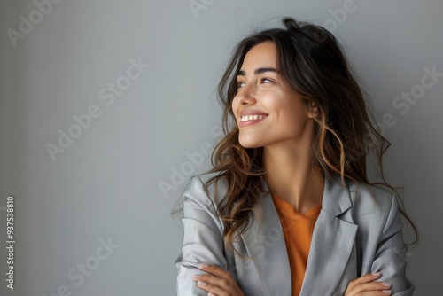 Smiling Businesswoman in Gray Blazer Looking Up with Hope