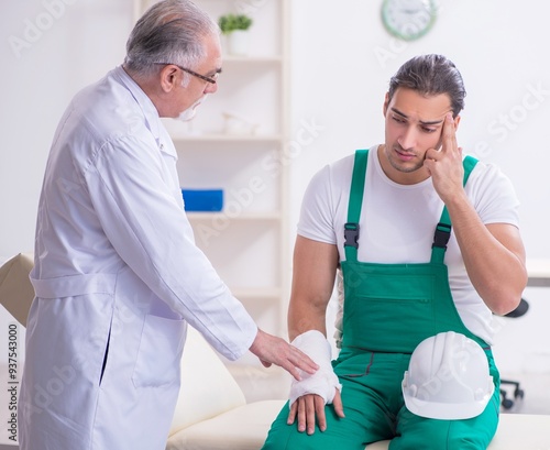 Young male contractor visiting old doctor