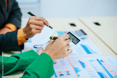 A group of professional business men and women are having a constructive meeting, discussing strategies, exchanging ideas and making decisions in a modern organization. They are wearing formal suits.
 photo