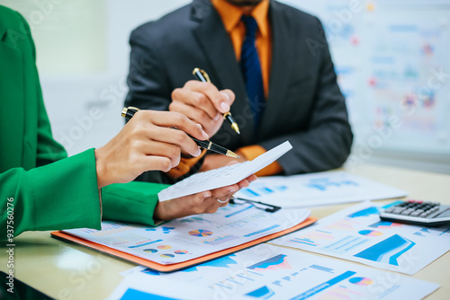 A group of professional business men and women are having a constructive meeting, discussing strategies, exchanging ideas and making decisions in a modern organization. They are wearing formal suits.
 photo