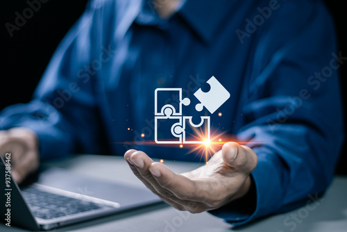 Konstfotografi Businessman use laptop with jigsaw icon for solution and leadership strategies concept