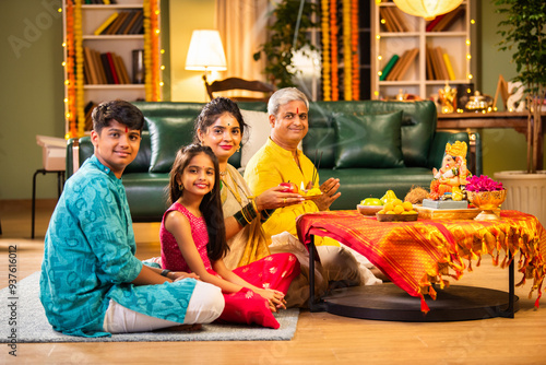 Konstfotografi Indian family celebrating Ganesh Chaturthi, performing puja with traditional rit