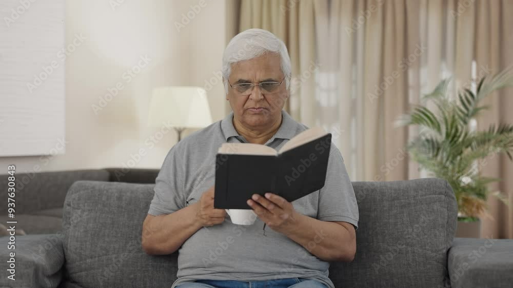 Serious Indian old man reading book in morning Serious Indian old man reading book in morning