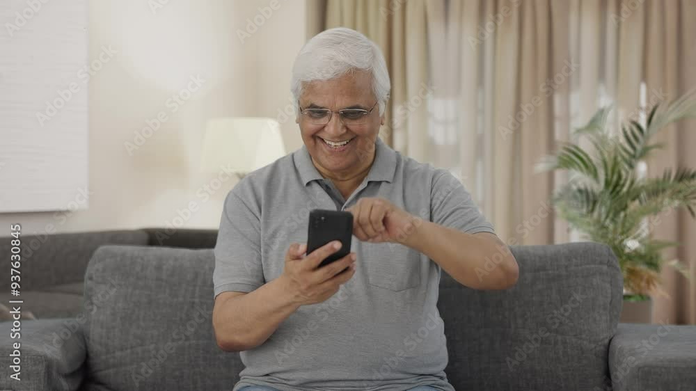 Happy Indian old man scrolling through phone Happy Indian old man scrolling through phone