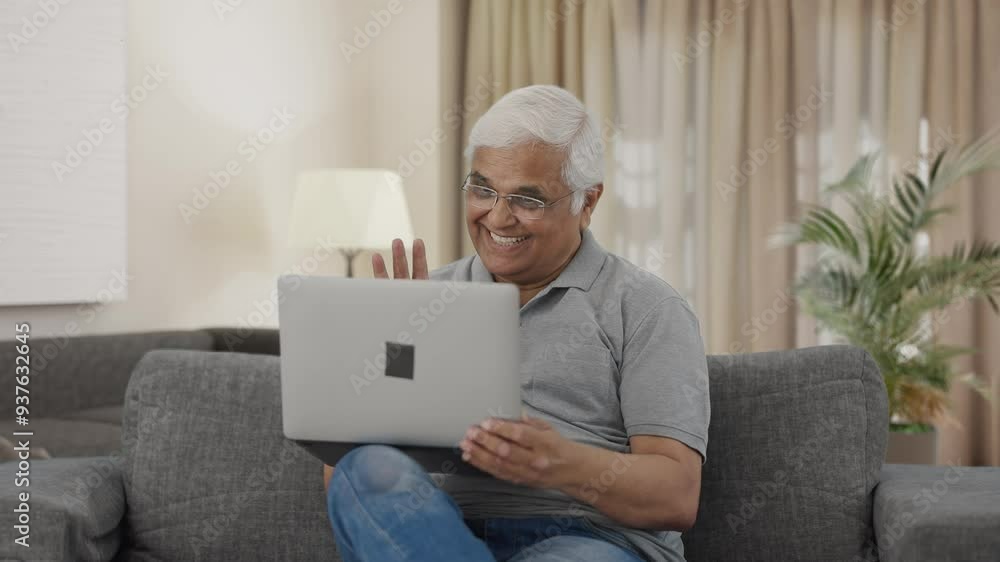 Happy Indian old man talking on video call on laptop Happy Indian old man talking on video call on laptop