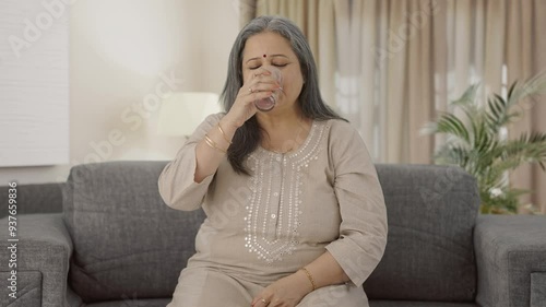 Relaxed old woman taking medicine
