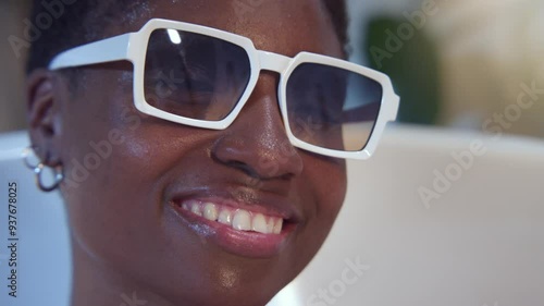 Wallpaper Mural Attractive black woman portrait smiling in bathtub with sunglasses looking at camera. High quality 4k footage Torontodigital.ca