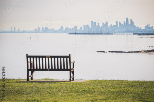 Fototapeta Naklejka Na Ścianę i Meble -  bench in the park with background Melbourne city
