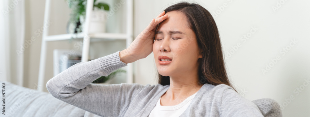 Young Asian females feeling dizzy after standing too fast, have symptoms of low blood pressure Young Asian females feeling dizzy after standing too fast, have symptoms of low blood pressure