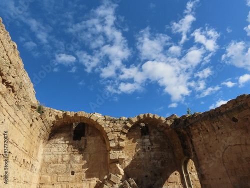Ruins of an ancient city in Caesarea in Israel against a background of blue sky and white clouds. An interesting journey through historical sights.