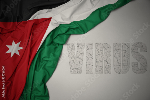 waving colorful national flag of jordan on a gray background with text virus . photo