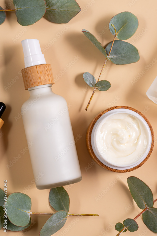 Natural cosmetics in bamboo and glass packaging on brown background with eucalyptus flowers. SPA organic beauty products set. Skin care concept. Natural cosmetics in bamboo and glass packaging on brown background with eucalyptus flowers. SPA organic beauty products set. Skin care concept.