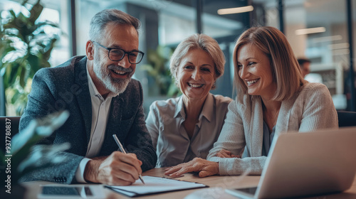 Happy senior couple during the meeting with agent or financial consultant, signing some agreement in the comfortable office