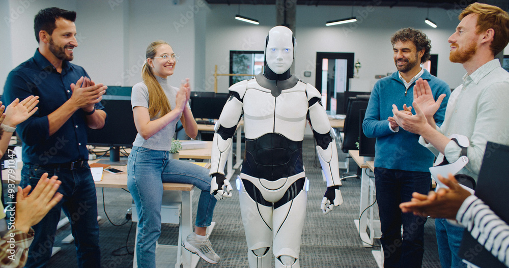 Fototapeta premium Robot walking in middle of room. Group of multi-ethnic coworkers clapping.