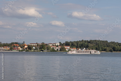 Wallpaper Mural A white tour boat navigates calm waters in front of the city of Waren, Germany,  on a sunny summer day Torontodigital.ca