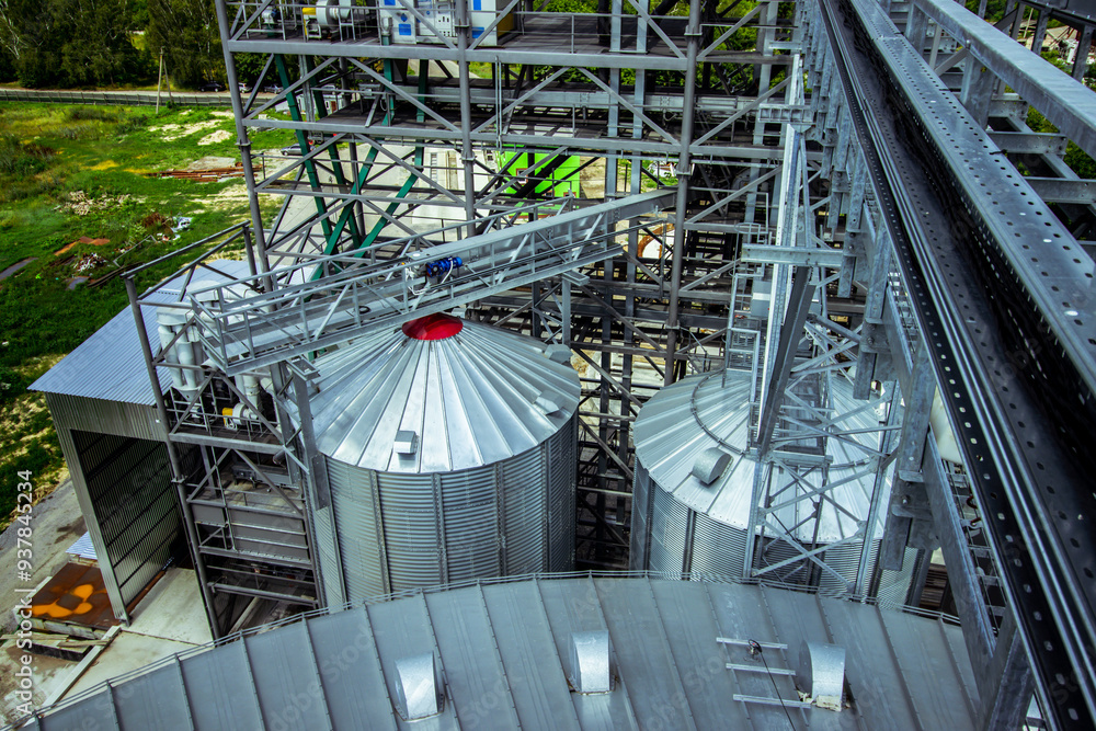 Agricultural Facility with Large Grain Silos. A vast agricultural facility with large grain silos, essential for the storage and management of harvested crops in modern farming.