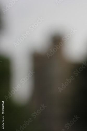 A dreamy view of a tall building standing in the distance.