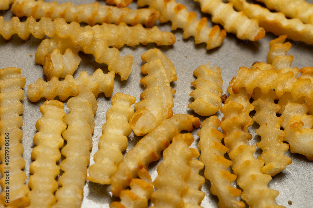 Crinkle cut french fries on a nonstick pan Crinkle cut french fries on a nonstick pan